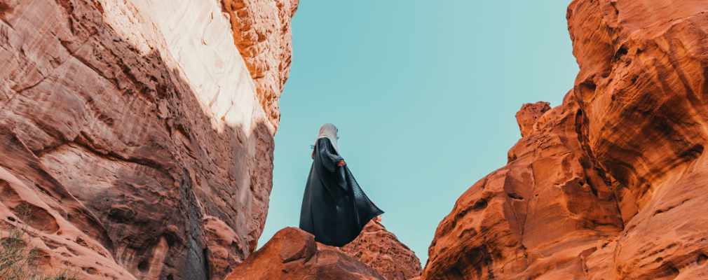 Persoon wandelt tussen de rotsen in de woestijn